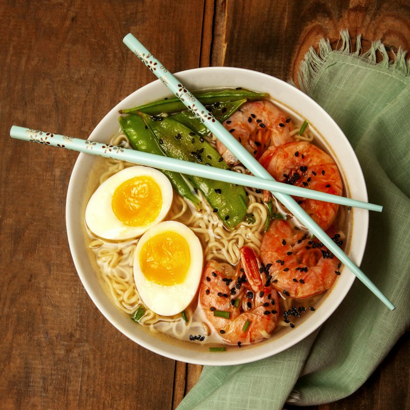 Steaming noodle bowl with dumplings, fresh rolls, and spring rolls — Friday special at RR & 3A's Cafe